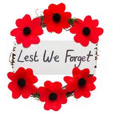 Image of a poppy wreath with Lest We Forget written across