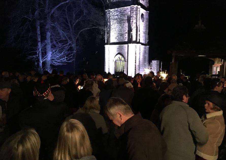 Crowd's gathered around the brazier in the square on New Year's Eve 2016