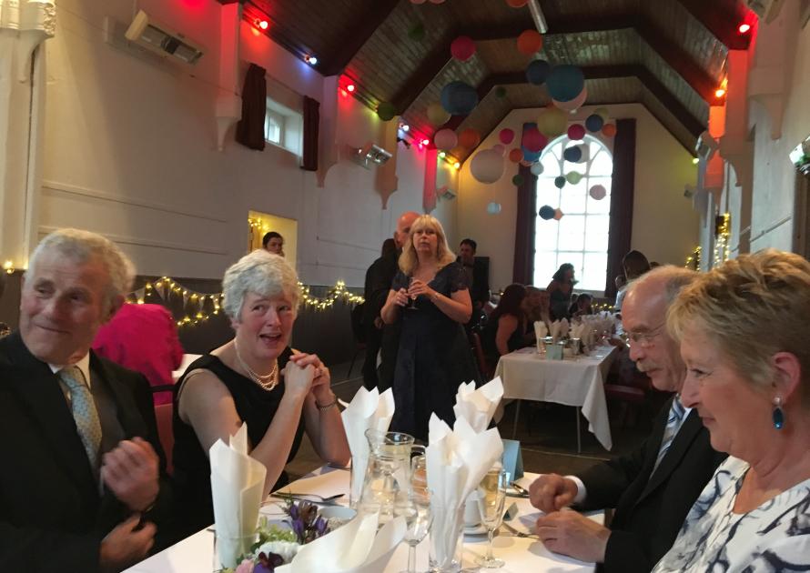 Guests sat at tables before meal at Summer Ball.