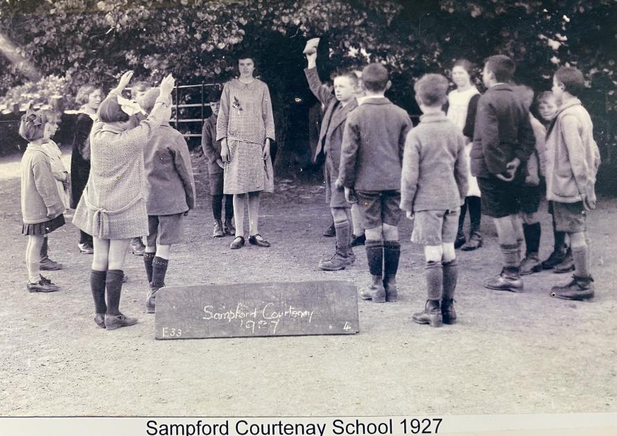 Black and white photo of school children in a school playground in 1927