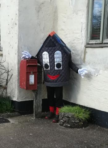 Picture of Roof-us standing beside a postbox