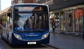 Public bus waiting at a stop on a street