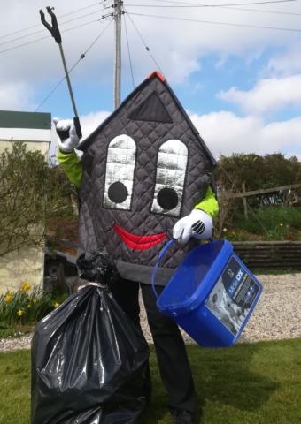 Roof-us with his bag a rubbish and a bucket doing the Village Spring Clean