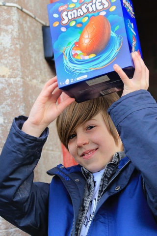Percy holding his Easter egg above his head in triumph