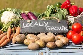 Picture of a selection of vegetables with a sign saying 'Locally Grown'