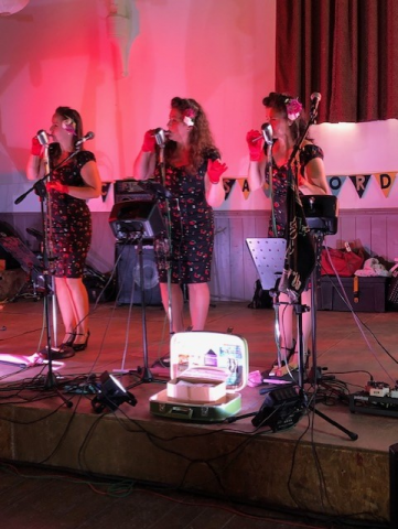 Photo of The Humming Birds and 3 piece girl 40's style singing group.