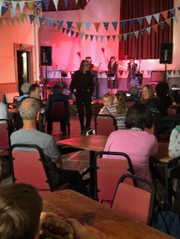 Photo of audience enjoying listening to live music.