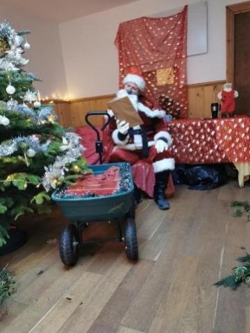 Picture showing Father Christmas sitting in his grotto waiting to greet children