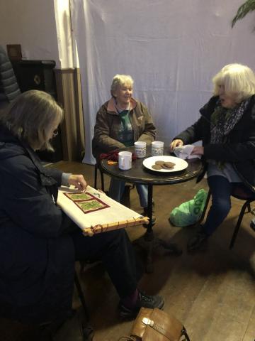 Photo of ladies in the village hall crafting