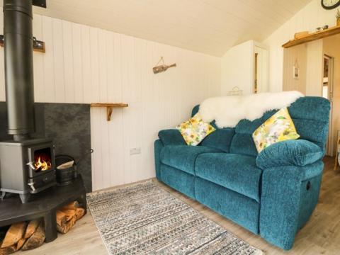 Photo of Langdale Lodge interior showing woodburning stove and settee