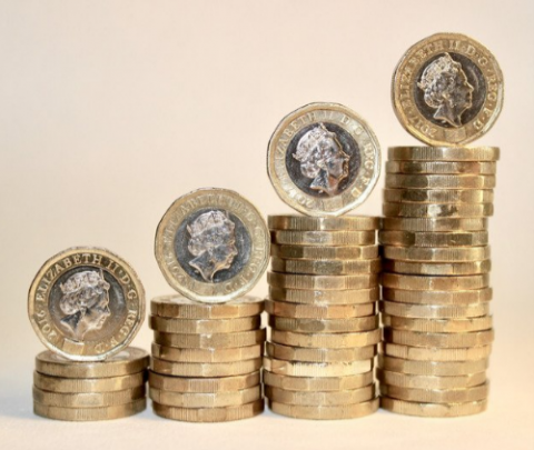 Picture of pound coins stacked up like steps.