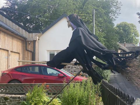 Picture of a witch on a broomstick scarecrow