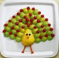 A peacock made from fruit.
