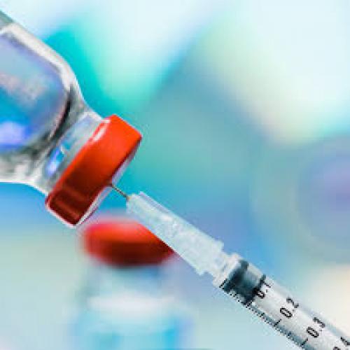 Image showing a vaccine being drawn a syringe from a bottle
