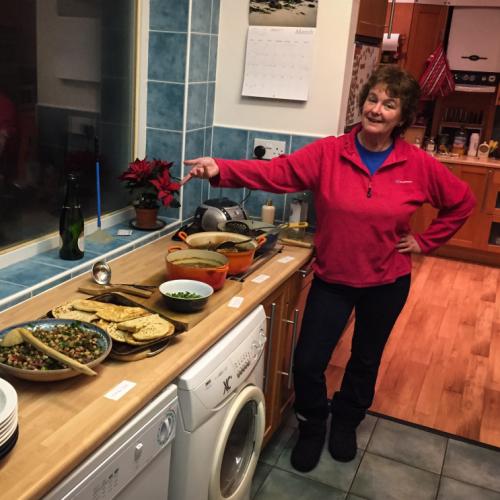 Photo of the cook showing off her currys in the kitchen