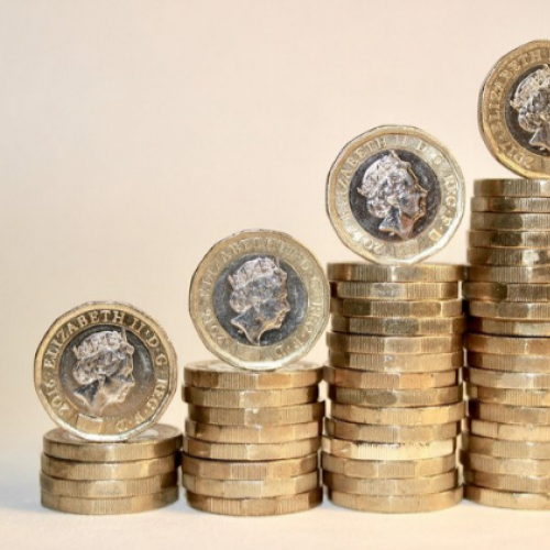 Picture of pound coins stacked up like steps.